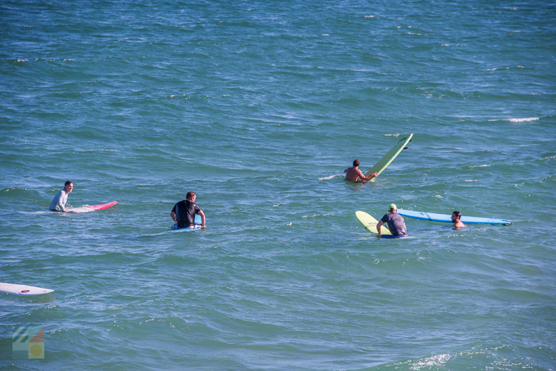 A group surfs in Wrightsville Beach